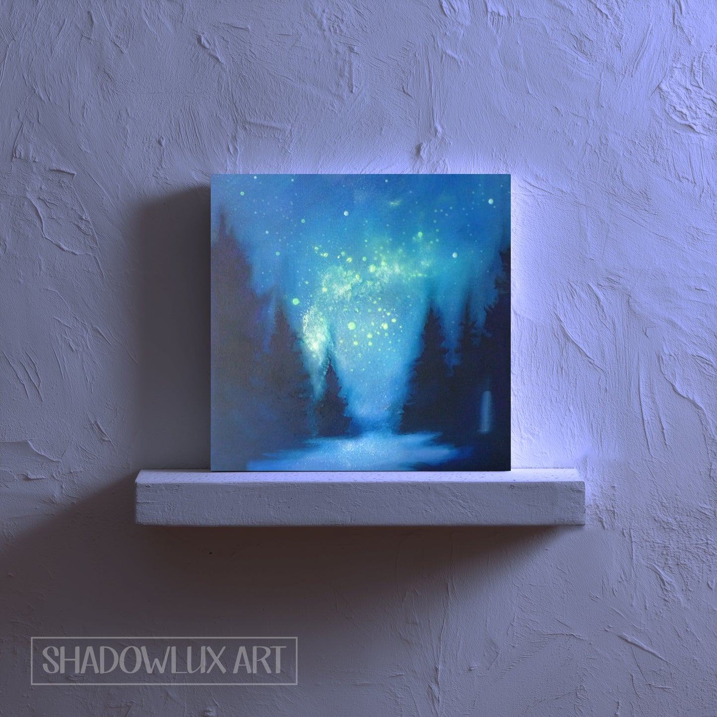 luminous artwork of a forest scene with a glow in the dark starry night sky on a textured wall.