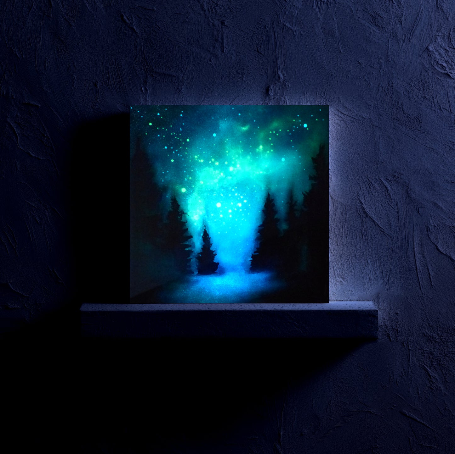 painting of a blue forest scene with glow in the dark trees on a textured wall at night.