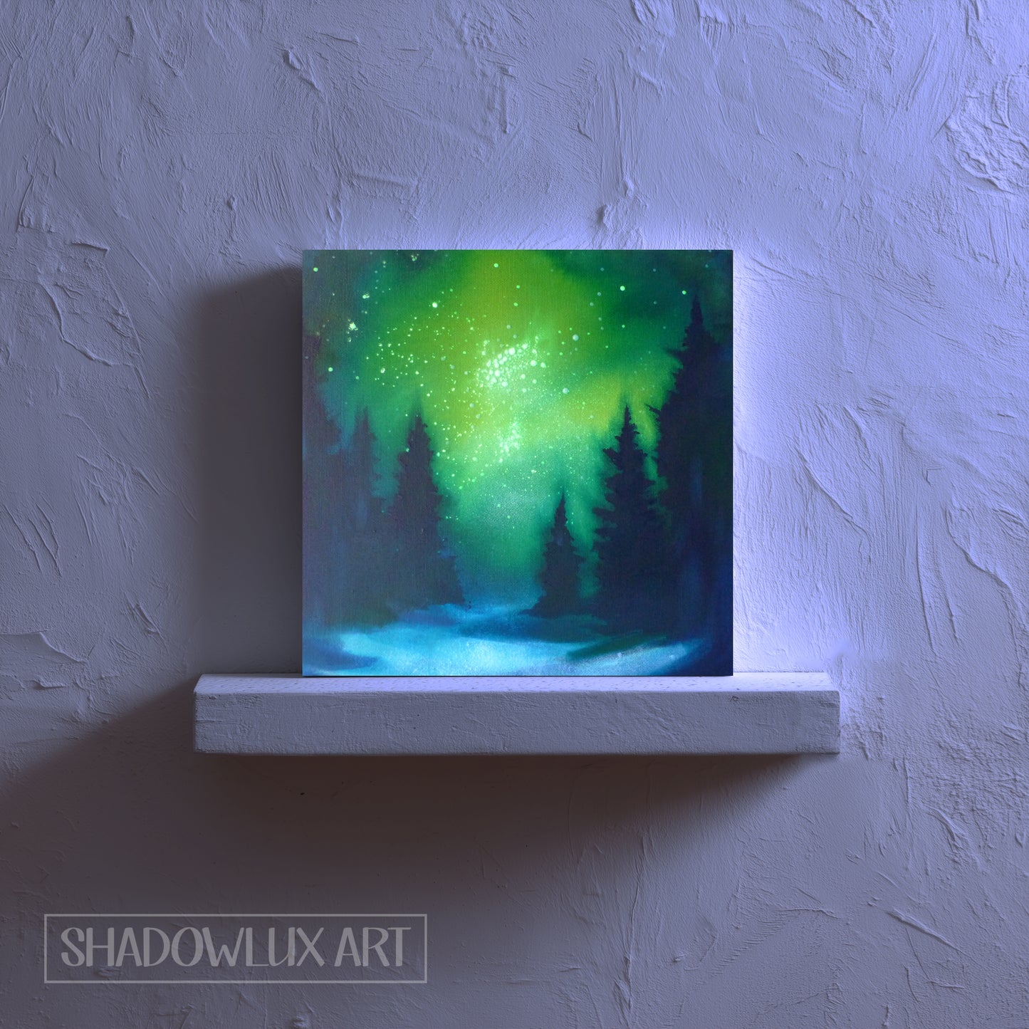 night light with green and blue glowing painting on a white shelf against a textured wall.