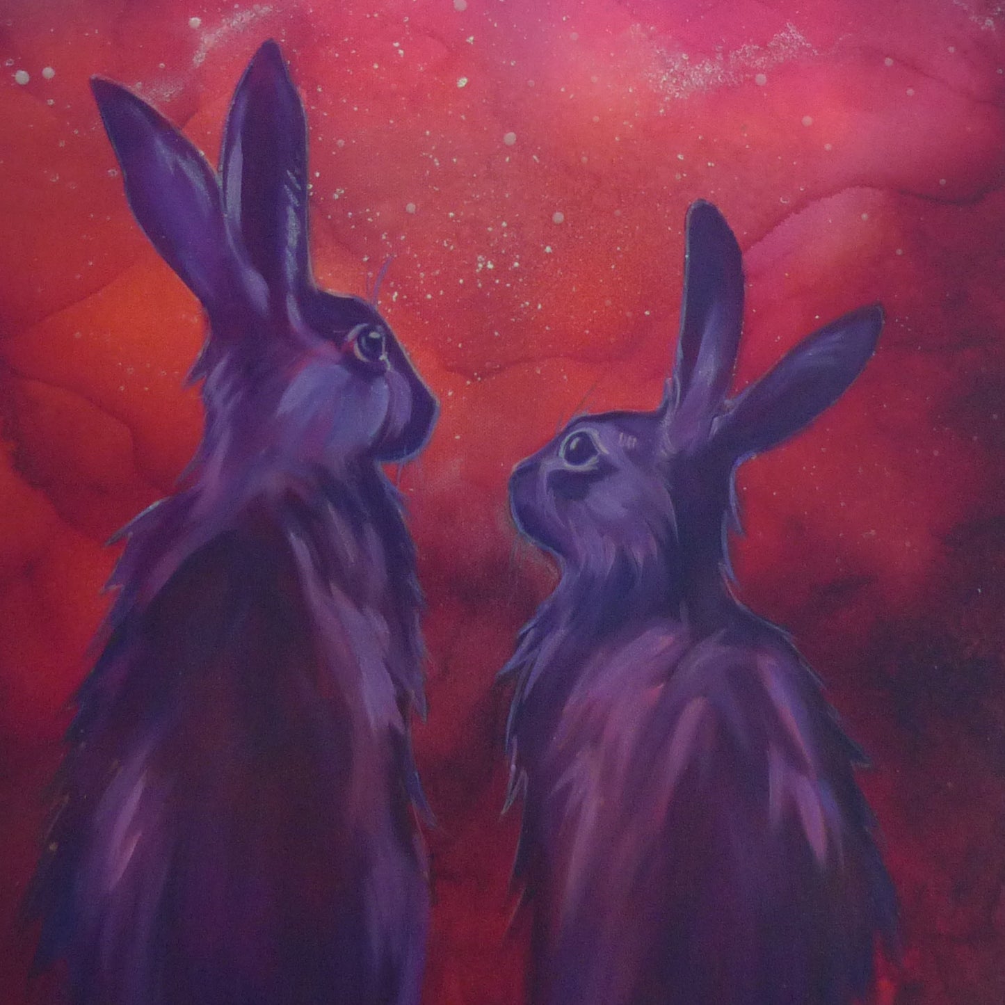 Two purple rabbits against a red and orange cosmic background that glows