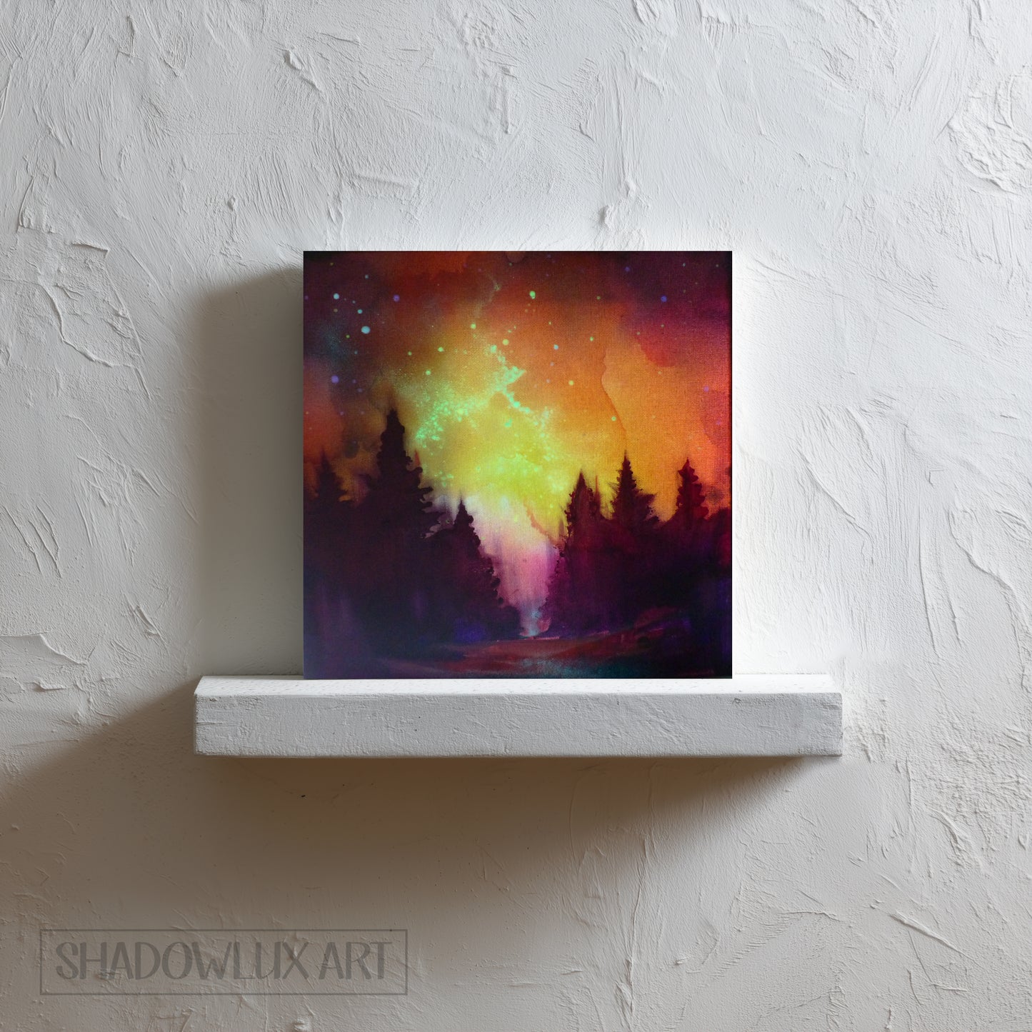 Colorful glow in the dark painting on a white shelf against a textured wall with 'Shadowlux Art' branding.