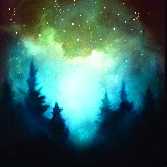 Silhouettes of trees against a vibrant glow in the dark nebula with stars