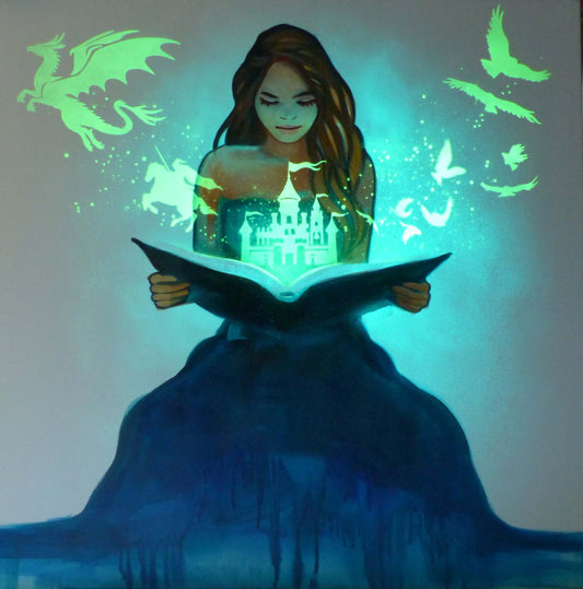 Woman reading a glowing book with magical glow in the dark elements like dragons and birds