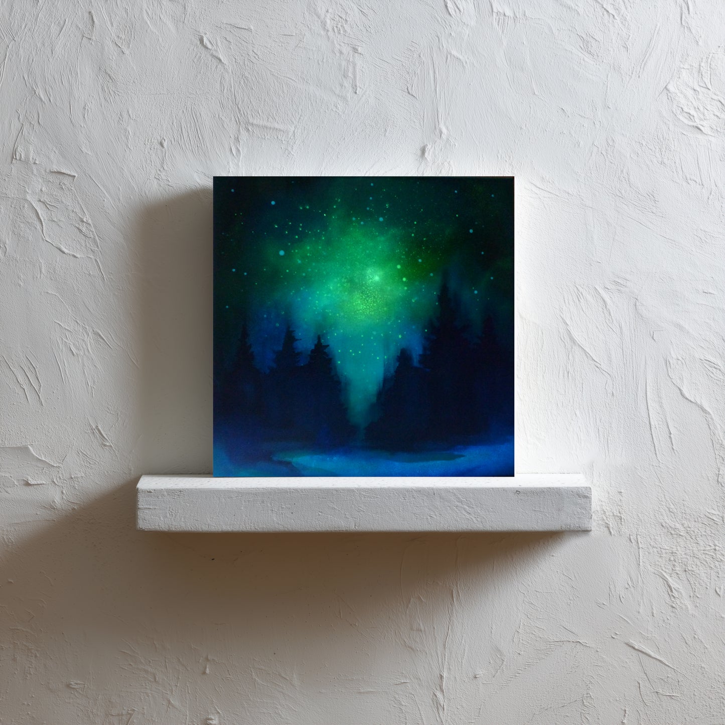 glow in the dark artwork of a celestial scene with green and blue hues on a white wall.