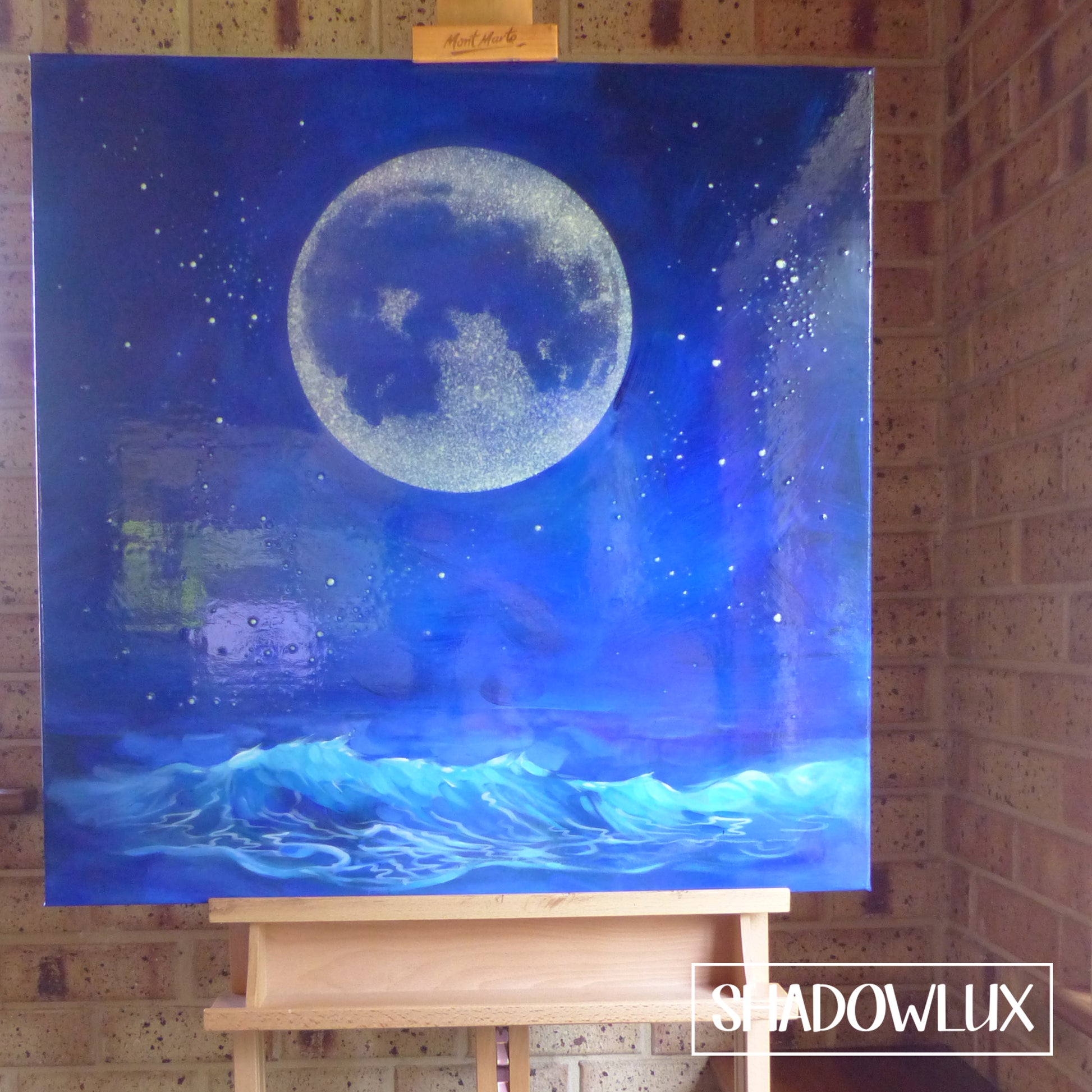 Hand-painted moon and beach scene in deep blues with glow in the dark wave details, photographed in daylight