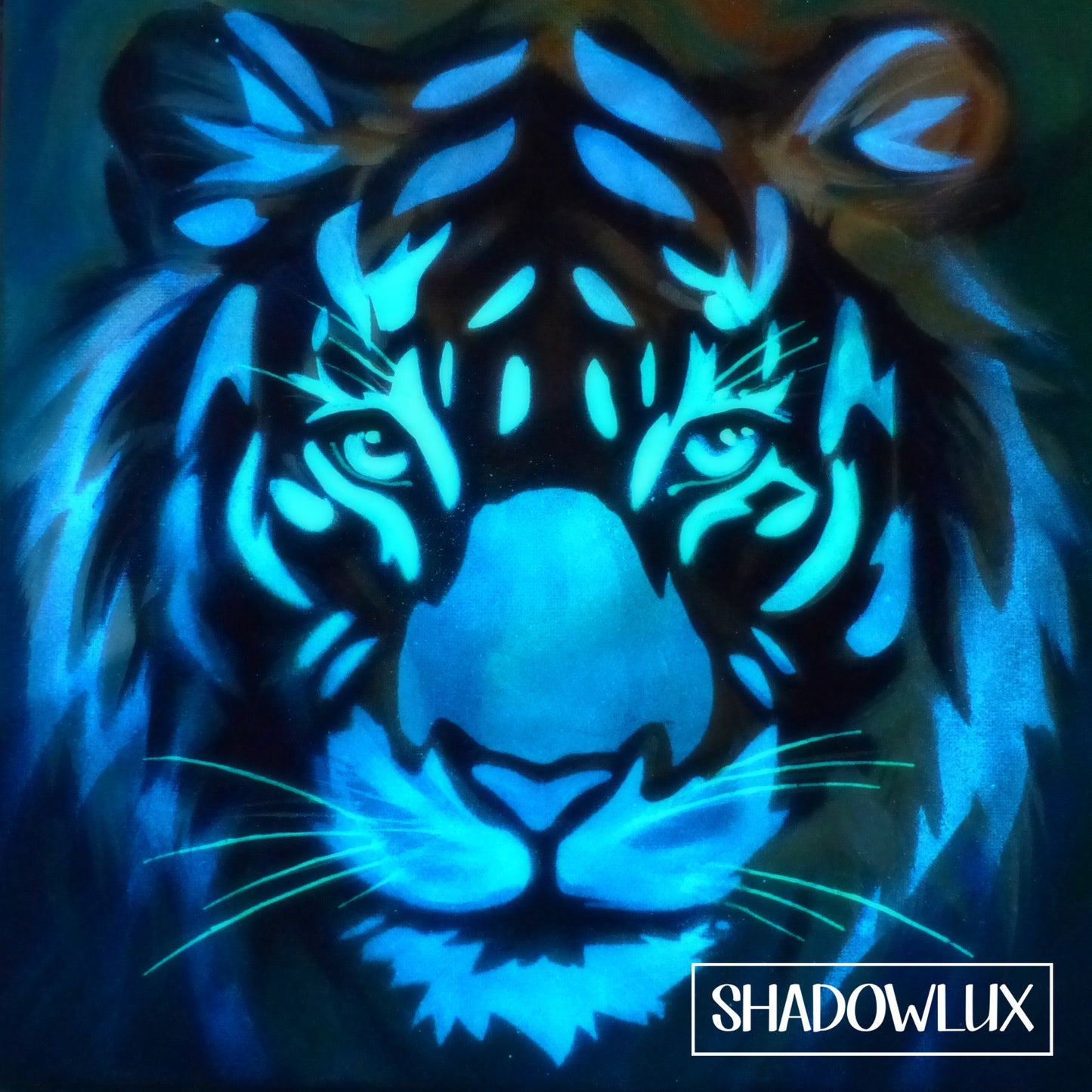 Glow in the dark painting of a tiger face with luminous details glowing in blues and greens