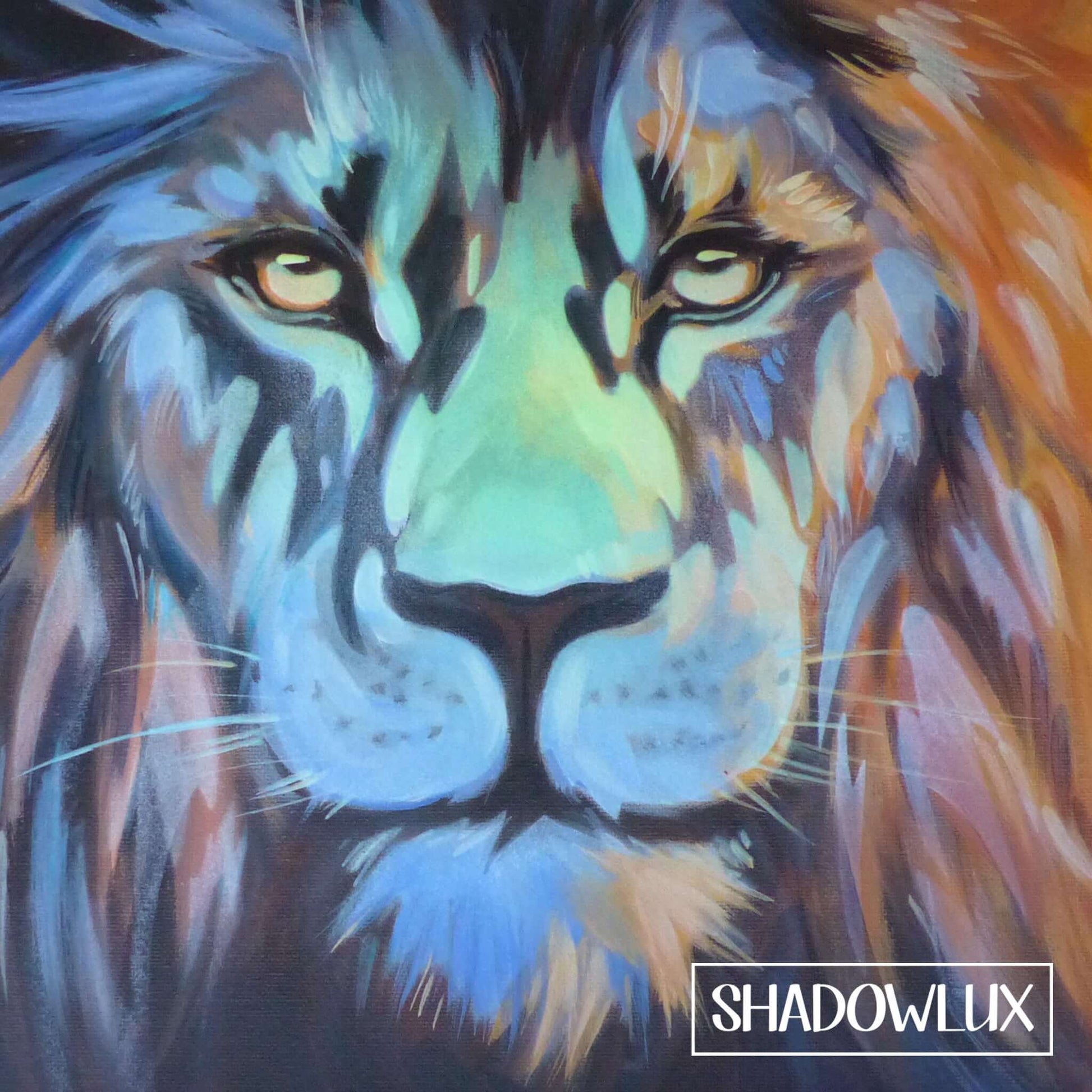 Detailed glow in the dark painting of a lion’s face illuminated with warm light and blue glow accents