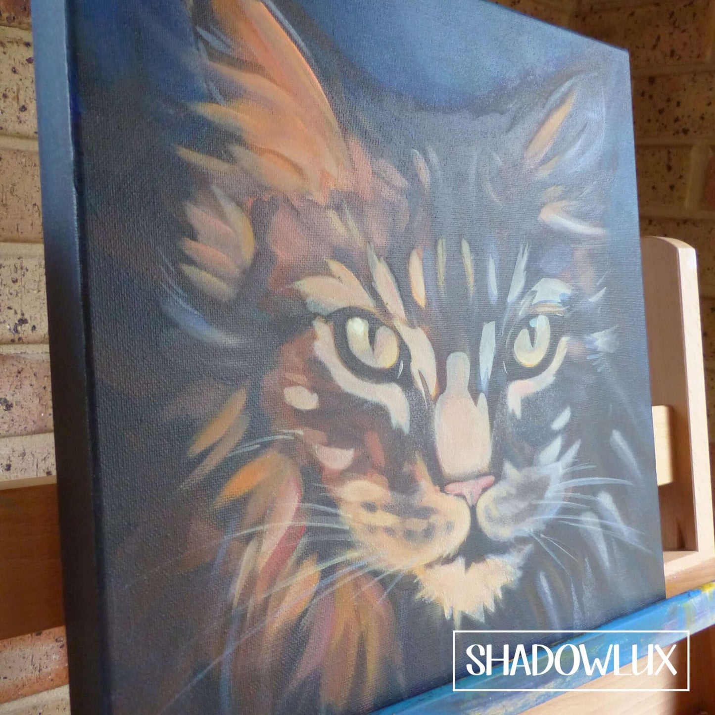 Hand-painted glow in the dark portrait of a cat with glowing details included on canvas