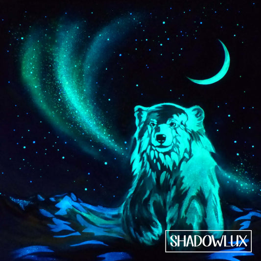 Glow painting of a snow bear standing in snow beneath a crescent moon and northern lights aurora