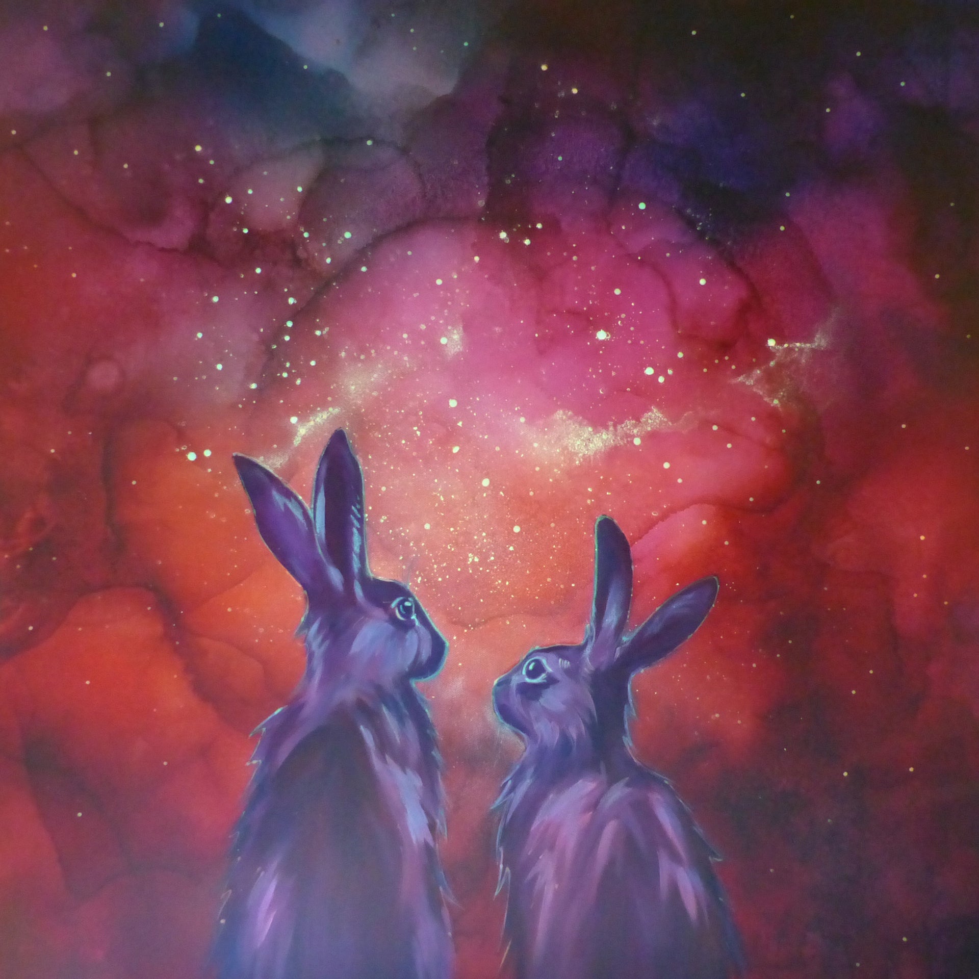 Two glow in the dark  rabbits gazing at a vibrant nebula in space