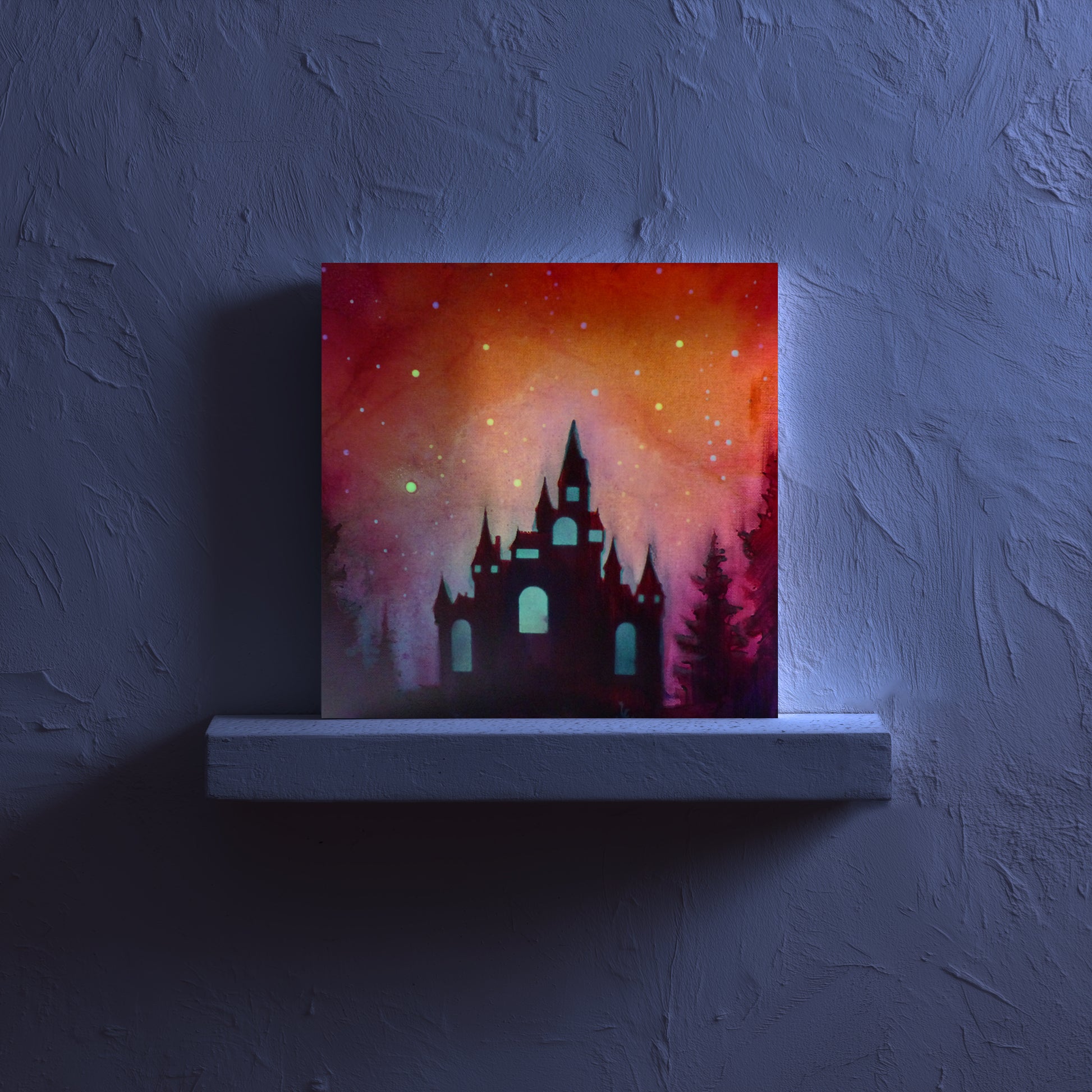 glow in the dark castle silhouette against a colorful sky on a dark wall.
