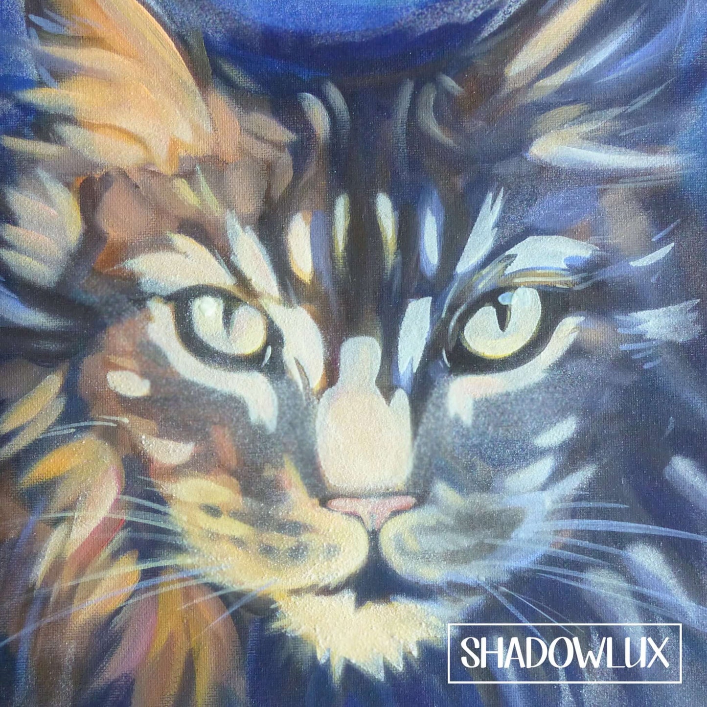 Glow in the dark painting of a cat face with glowing eyes, on a small-format wall art canvas